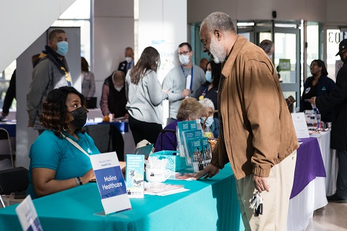 Man interacting with a MetroHealth employee at the Minority Men's Health Fair