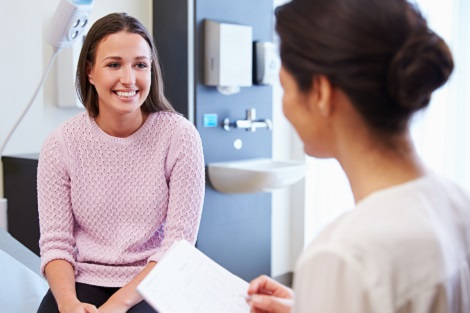 Woman having discussion with her physician