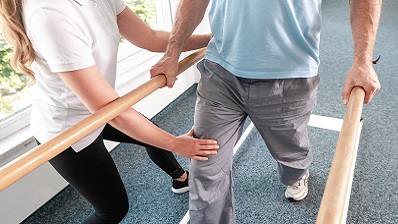 physical therapist working with rehabilitation patient