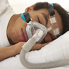 Man wearing CPAP mask to assist with sleeping