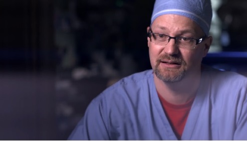 Jeffrey Claridge, MD on the trauma unit in scrubs