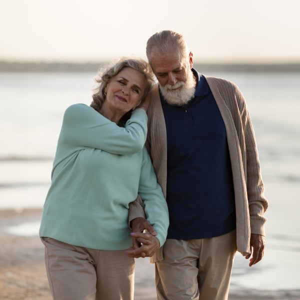 Senior couple walking on the beach