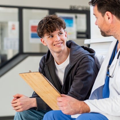 A teenager talking with a doctor