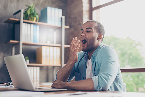 Person yawning who may be suffering from sleep apnea
