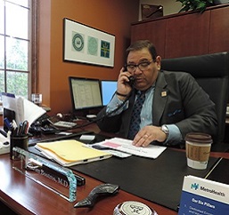 Akram Boutros MD seated at desk working