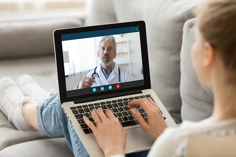 woman talking with doctor on computer video call