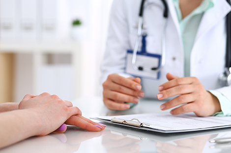 Physician sitting down to discuss treatment options with a patient