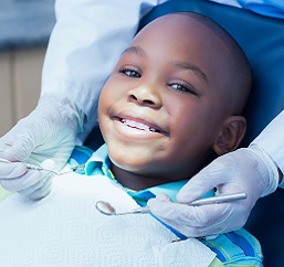boy in dentist chair smiling
