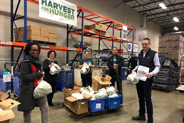 MetroHealth employees working at a Harvest for Hunger food distribution event