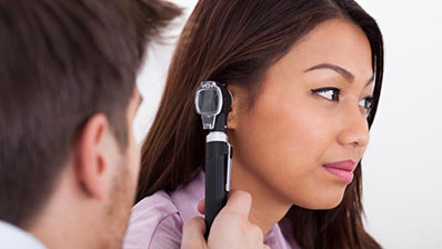 Woman getting an ear exam