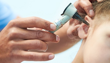 young boy having his ears examined