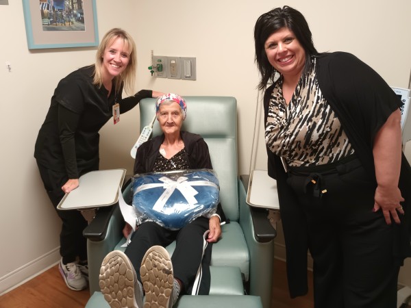 A MetroHealth patient receiving a gift blanket