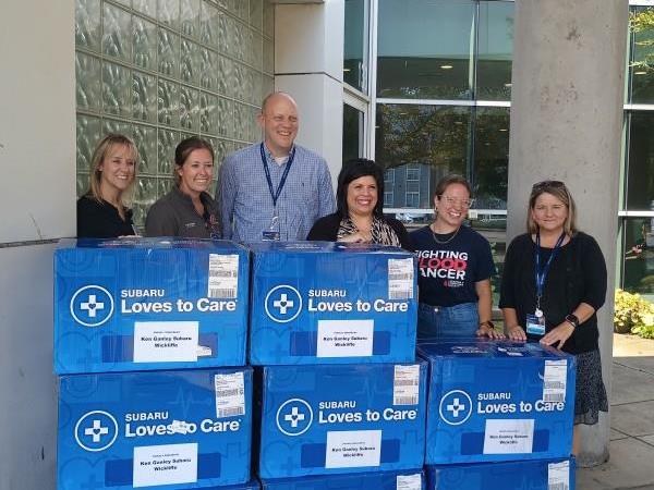 Representatives from Ken Ganley Subaru, the Leukemia & Lymphoma Society, and MetroHealth with Subaru Loves to Care donation boxes