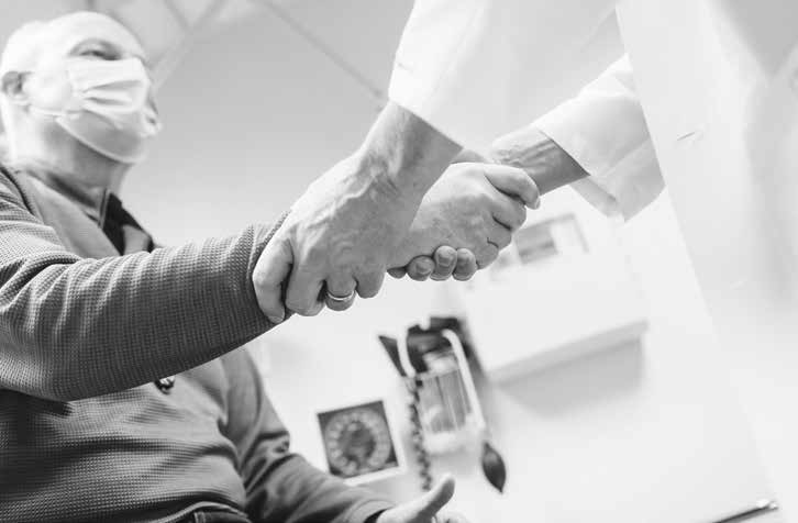 Patient having pulse checked by doctor