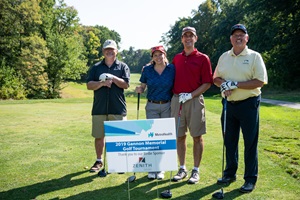 Gannon Golf Tournament 2019 Attendees Posing with Event Sign