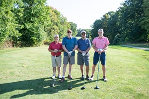 Gannon Golf Tournament Attendees Posing with Clubs