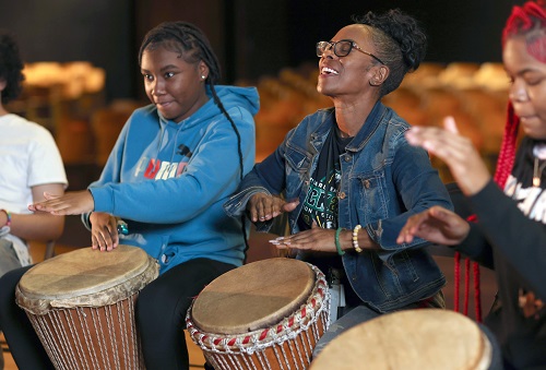 Young women playing drums as part of MetroHealth Healing Through the Arts Program