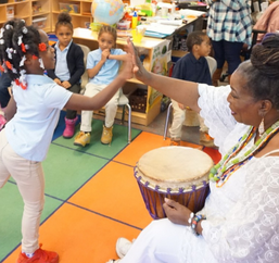 Student dancing to beat of a drum as part of participating in Arts Program