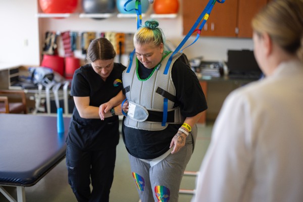 A woman walking with assistance in the Rehabilitation Center