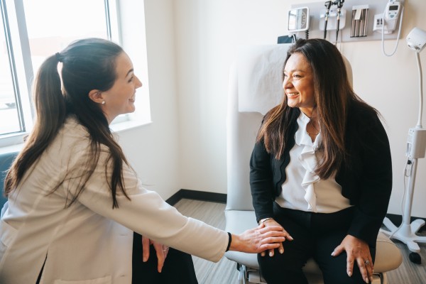A patient having a happy conversation with her doctor