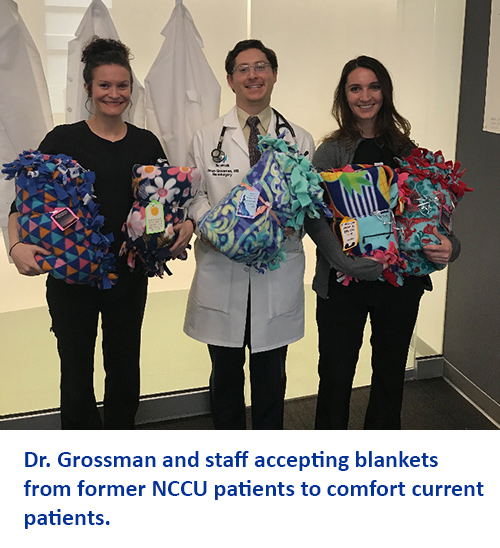 NCCU physician Jonah Grossman, MD and staff holding donated blankets for neurocritical care unit at MetroHealth  500