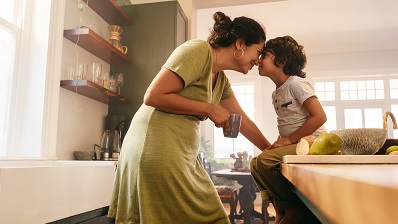 Mother and son in kitchen enjoying each other's company