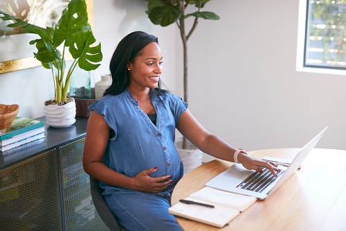 pregnant woman working on a computer