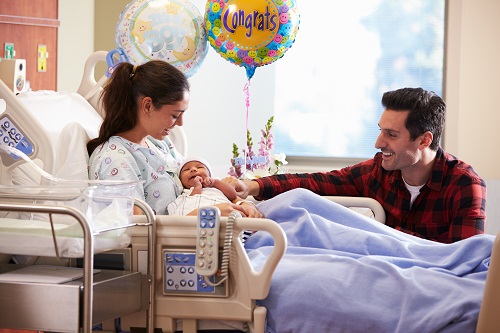 woman and man in birthing center with newborn child