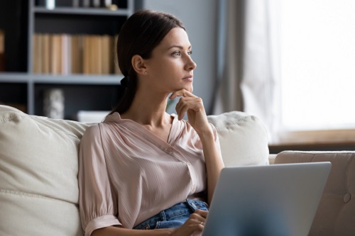 Woman on couch with laptop