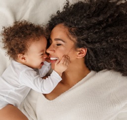 Mom and baby bonding in bed