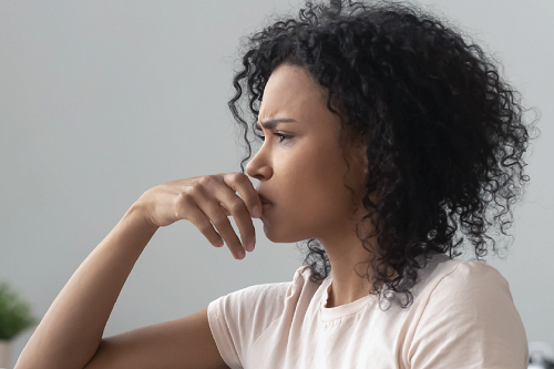 woman on couch staring out window