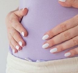 woman touching pregnant belly