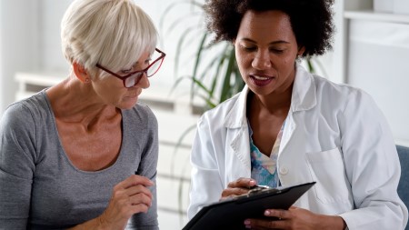 Doctor discussing paperwork with patient