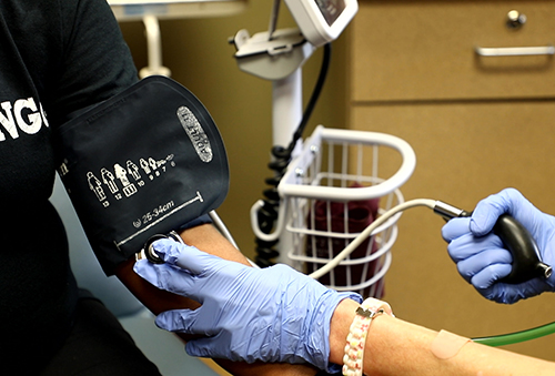Nurse taking patient's blood pressure