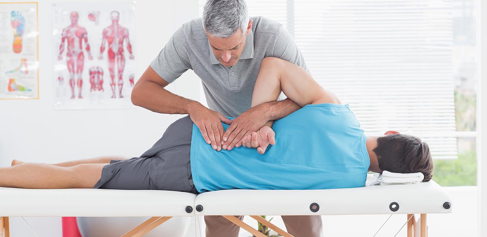 Spine specialist examining a patient in an exam room