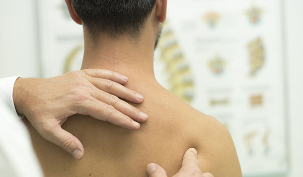 Picture of physician examining a patient's back