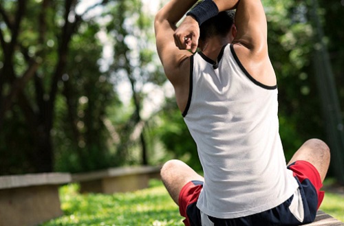 Woman stretching in a park before exercising