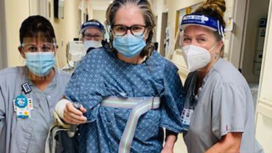Sabel being helped down the hallway at hospital