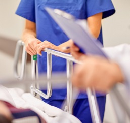 MetroHealth providers wheeling patient down hallway