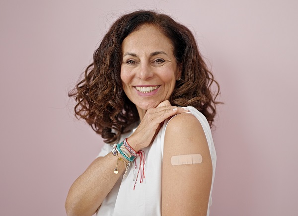 woman with band aid after vaccination