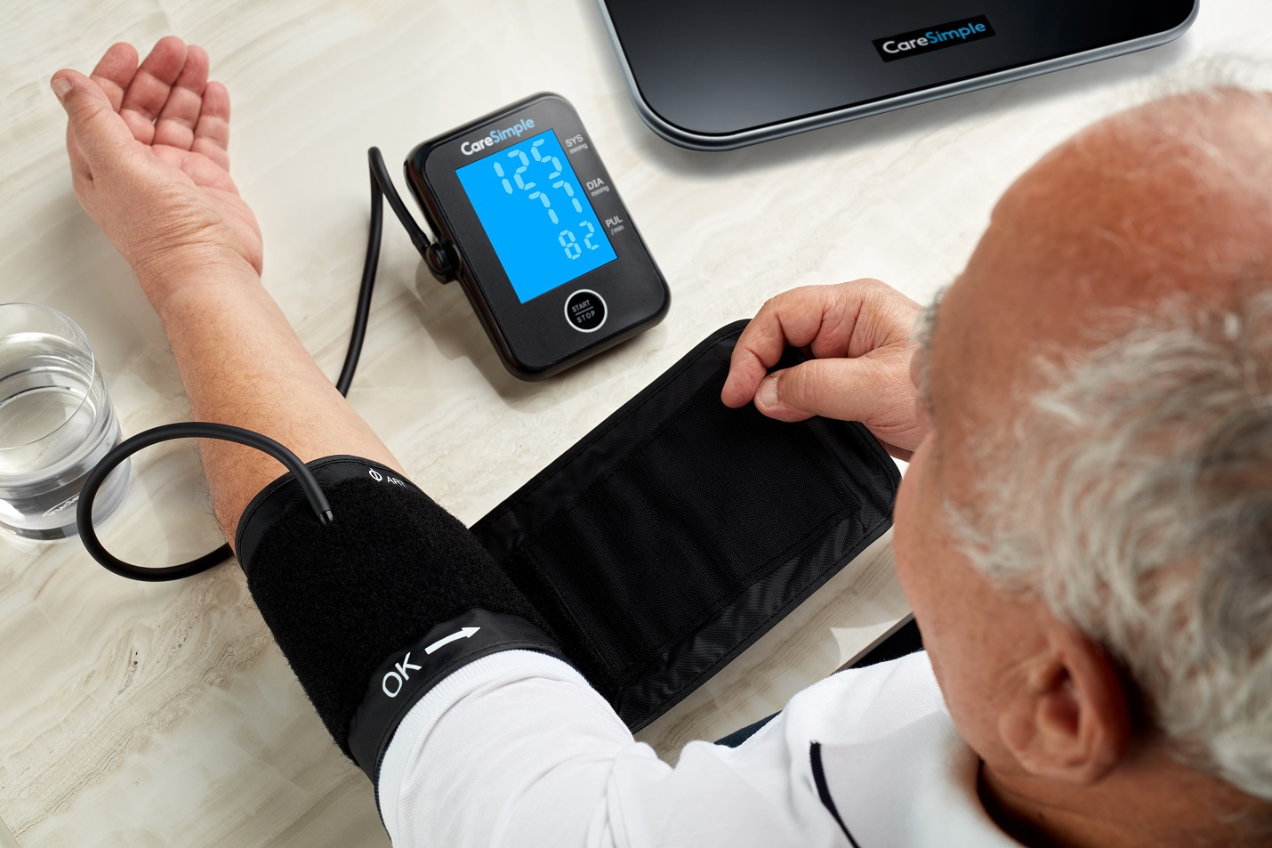 Man taking vital signs using the CareSimple monitor
