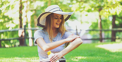 Woman putting on sunscreen