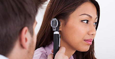 Doctor looking in patient's ears