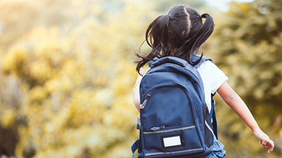 Child running with backpack