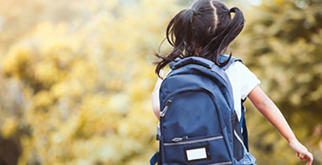 Child with backpack running