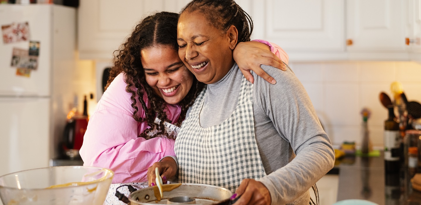 woman and grandmother in kitchen cooking