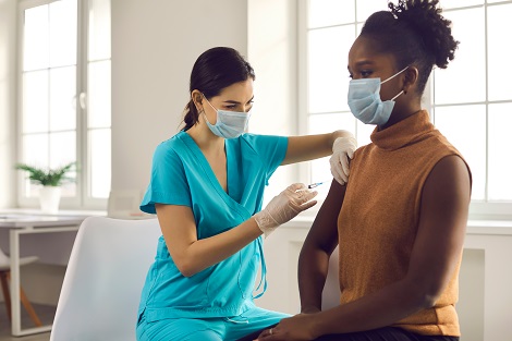 Health care provider vaccinating a patient