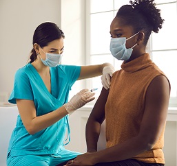 Health care provider vaccinating a patient