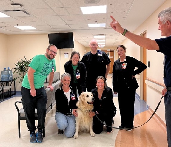 Employee Health Center team with Denver the Loving Paws dog