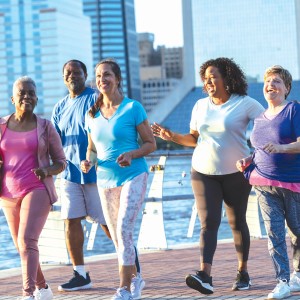 A group of people walking at a riverfront